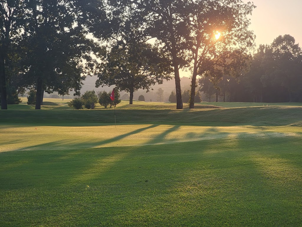 Panoramic view of a lush green golf course at Winn Mountain Golf Course. Smooth