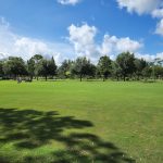 Panoramic view of a lush green golf course at Winter Park Golf Course. Smooth
