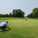 green grass with the flag in the hole.