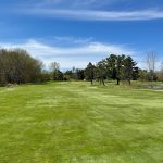 Panoramic view of a lush green golf course at Wisconsin River Golf Club. Smooth