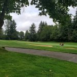 Panoramic view of a lush green golf course at Witch Hollow Golf Course. Smooth