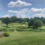Panoramic view of a lush green golf course at Woodholme Country Club. Smooth