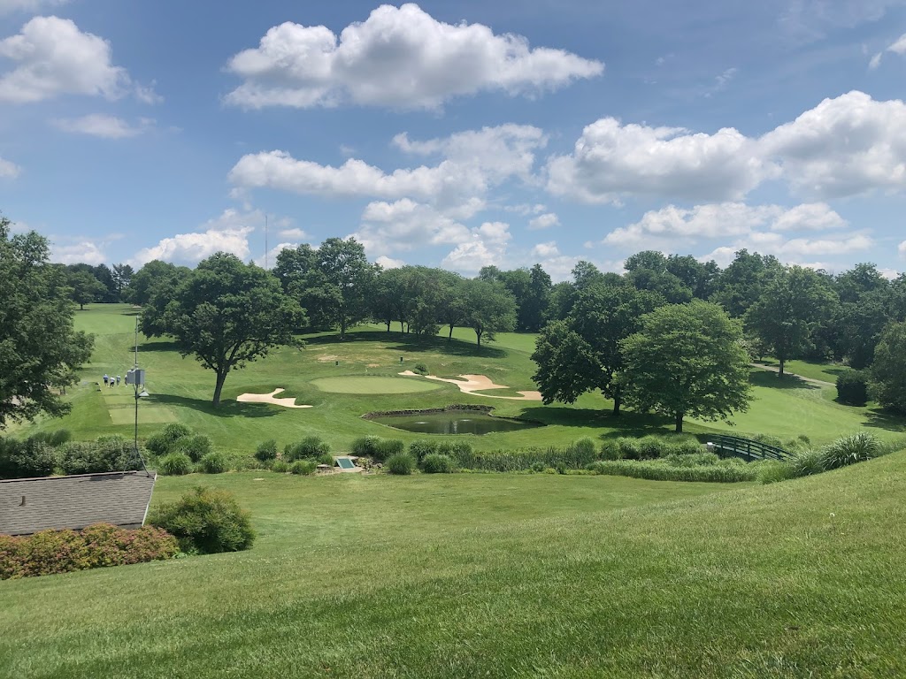 Panoramic view of a lush green golf course at Woodholme Country Club. Smooth