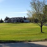 Panoramic view of a lush green golf course at Woodland Golf Club. Smooth