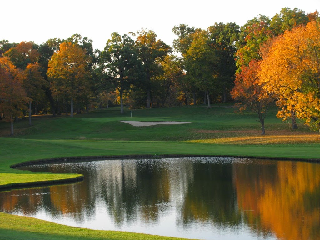 Panoramic view of a lush green golf course at Woodland Golf Club. Smooth