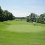 Panoramic view of a lush green golf course at Woodlands Course at Whittaker. Smooth