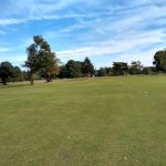 Panoramic view of a lush green golf course at Woodlands Golf Course. Smooth