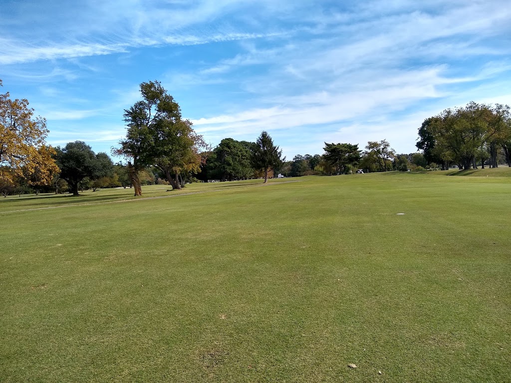 Panoramic view of a lush green golf course at Woodlands Golf Course. Smooth