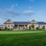 Panoramic view of a lush green golf course at Woodmont Country Club. Smooth