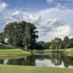 Panoramic view of a lush green golf course at Woodmont Golf and Country Club. Smooth