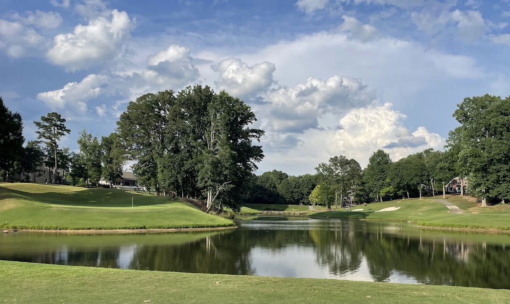 Panoramic view of a lush green golf course at Woodmont Golf and Country Club. Smooth