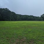 Panoramic view of a lush green golf course at Woodstock Golf Course. Smooth