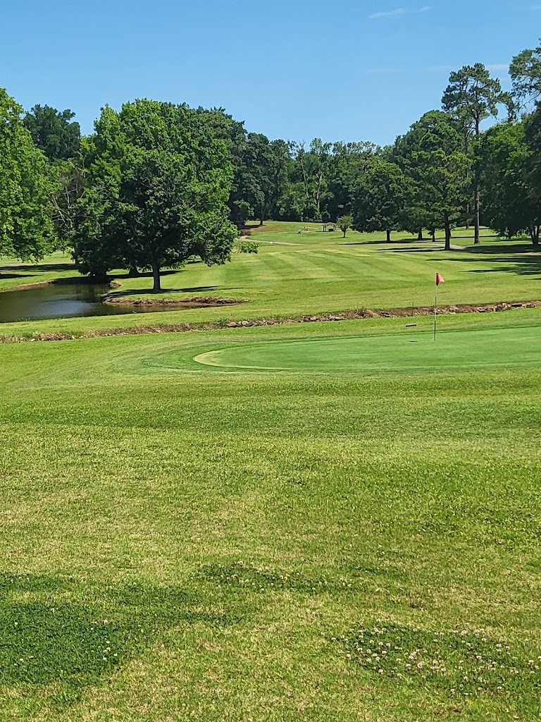 Panoramic view of a lush green golf course at Woodward Golf Club. Smooth