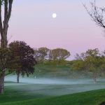 Panoramic view of a lush green golf course at Woodway Country Club. Smooth