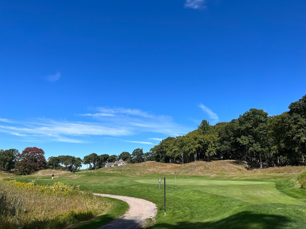 Panoramic view of a lush green golf course at Yale Golf Course. Smooth