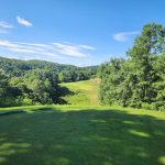 Panoramic view of a lush green golf course at Yatesville Lake Golf Course (Eagle Ridge). Smooth