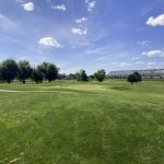 Panoramic view of a lush green golf course at Yegen Golf Club. Smooth