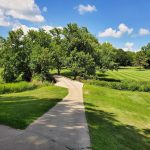 Panoramic view of a lush green golf course at York Country Club. Smooth