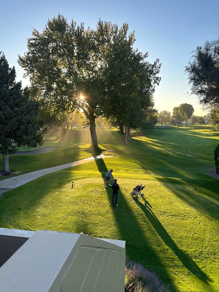 Panoramic view of a lush green golf course at Zintel Creek Golf Course. Smooth