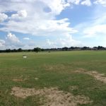 Panoramic view of a lush green golf course at First Tee - Northwest Arkansas. Smooth