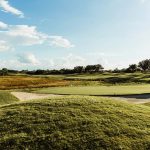 Panoramic view of a lush green golf course at Granada Golf Course. Smooth