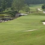 Panoramic view of a lush green golf course at Greystone Golf and Country Club. Smooth