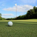 Panoramic view of a lush green golf course at Highland Golf Course. Smooth