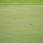 Panoramic view of a lush green golf course at Highland Golf Course. Smooth