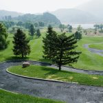 Panoramic view of a lush green golf course at Tamarisk Golf Course. Smooth