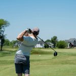 Panoramic view of a lush green golf course at Wellman Golf Course. Smooth